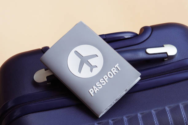 istock Passport placed on blue suitcase on cream background with copy space. 1252152800