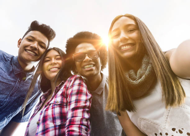 istock Happy diverse friends taking a selfie while hanging out 1252179106