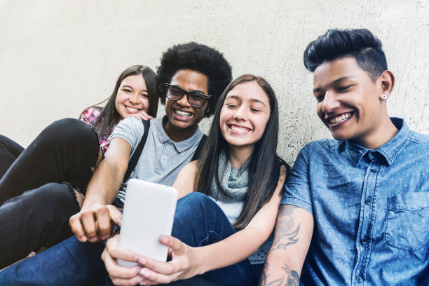 istock Happy multi ethnic group of friends taking selfies smiling 1252179153