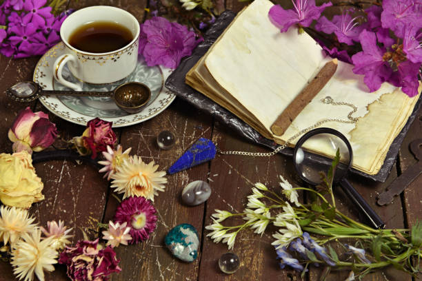 istock Still life with open diary book, cup of coffee and crystal stone on witch table. 1252185365
