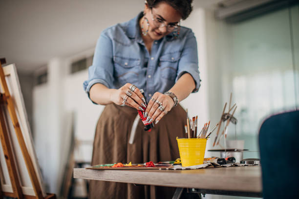 istock Cute female painter mixing colors in art studio 1252195931