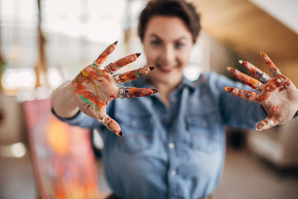 istock Cute female painter with dirty hands in art studio 1252197765