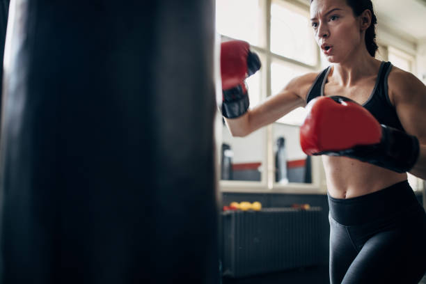 istock Female boxer training alone in gym 1252204512