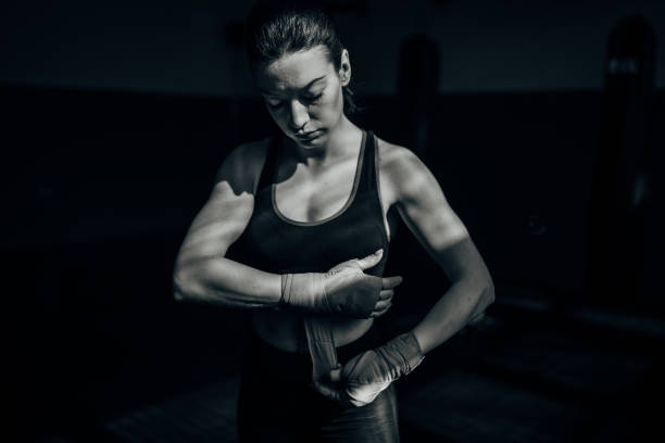 istock Female boxer wrapping bandages on hands 1252204584