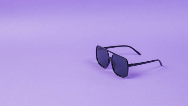 istock Stylish sunglasses on a light purple background. 1252205722