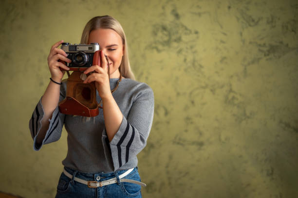 istock beautiful girl with a camera in her hands, on a blurred background 1252205723