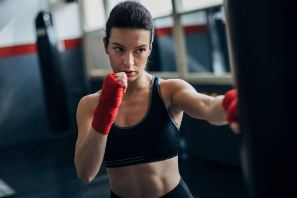 istock Female boxer training alone in gym 1252206062
