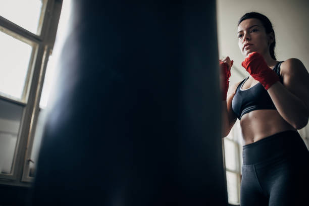 istock Female boxer training alone in gym 1252208191