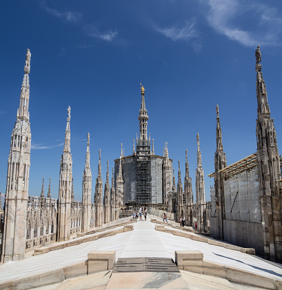 Milano, Italy. The roof of Milan Cathedral visited by tourists. The largest walkable roof in the world belonging to a Gothic cathedral