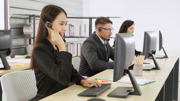 istock Business people wearing headset working in office 1252247626