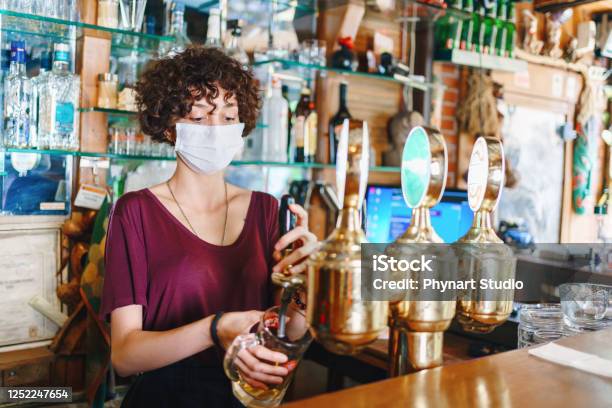 Masked Bartender Filling Beer Stock Photo - Download Image Now - Coronavirus, Pub, Bar - Drink Establishment