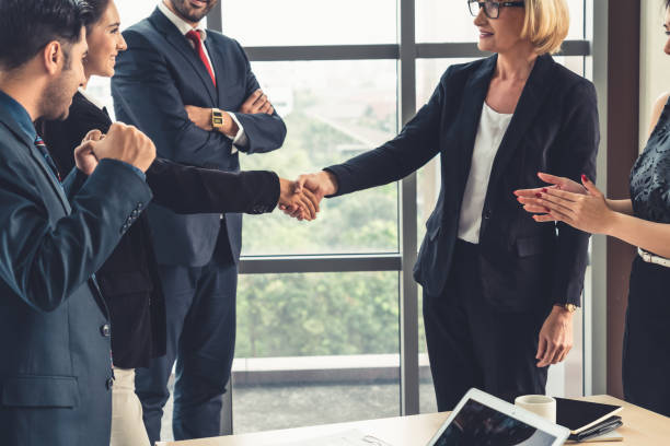 istock Business people handshake in corporate office 1252249508
