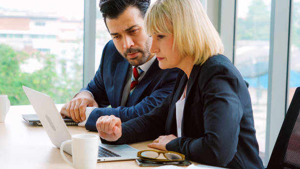 istock Two business people talk project strategy at office 1252249536