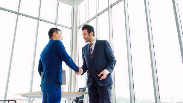 istock Business people handshake in corporate office 1252249620
