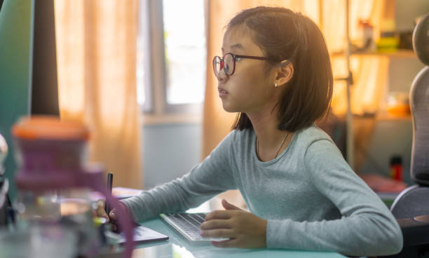 istock Asian little girl using digital pen drawing at home 1252256869