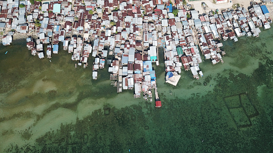 Fishing village in Borneo, Malaysia. Refugees from Philippines live in these shanty towns which are at risk from rising sea levels, climate change and tsunamis