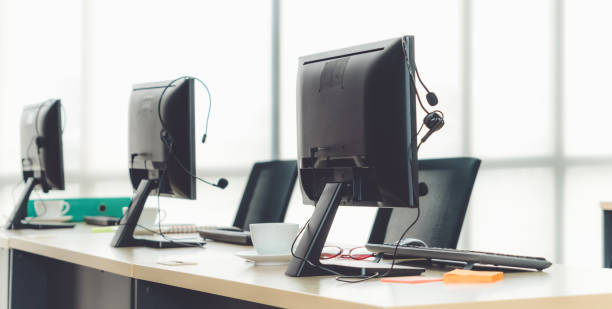 istock Call center computers and headsets all in office 1252264317