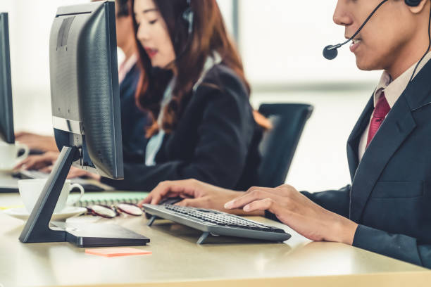 istock Business people wearing headset working in office 1252264389