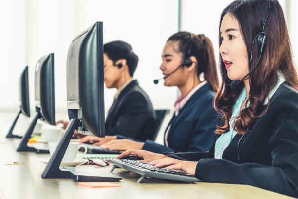 istock Business people wearing headset working in office 1252264390