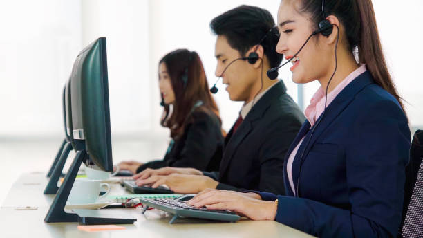 istock Business people wearing headset working in office 1252264391