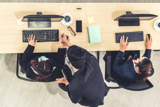 istock Business people wearing headset from top view in office working with computer 1252264398