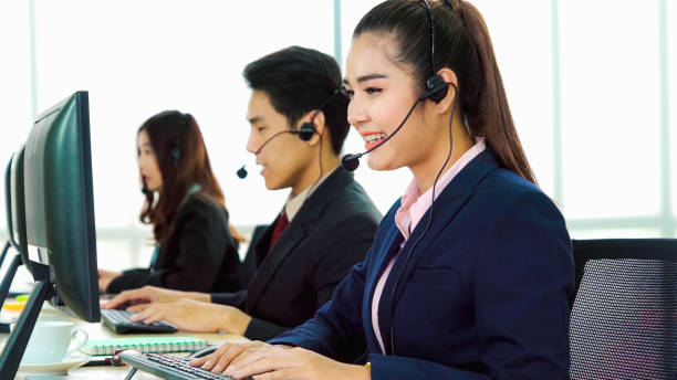 istock Business people wearing headset working in office 1252264403