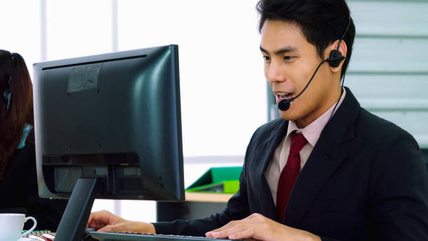 istock Business people wearing headset working in office 1252264536
