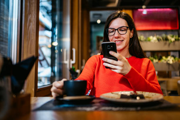 istock Woman chatting on phone in cafe 1252265535