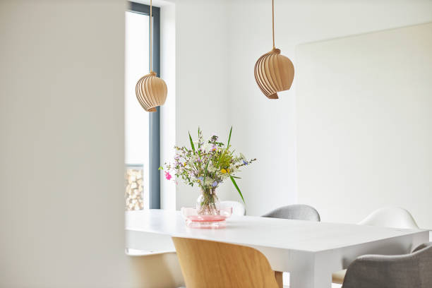istock Different photos of a decorated white dining table in a bright environment with flowers and a flower vase 1252270134