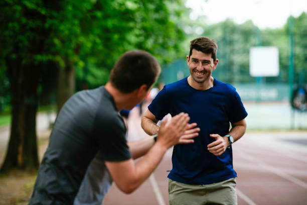 istock Two young friends running on athletics track 1252270775