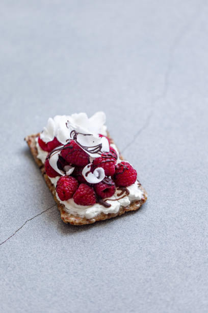 Cracker with strawberry jam and butter