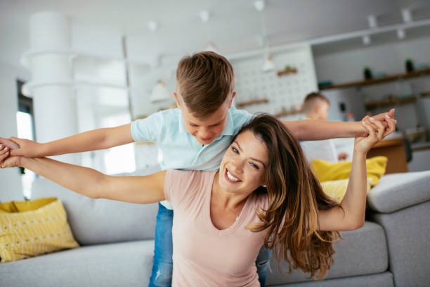 istock Mother and son playing in living room. 1252274289