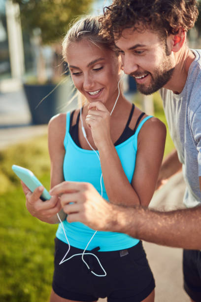 istock Modern couple making pause on the sidewalk during jogging / exercise. 1252275539