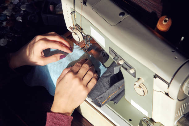 istock Woman tailor using retro sewing machine at home, hobby concept. 1252276090