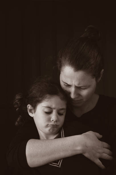 istock Upset mother and daughter isolated on black background 1252276689