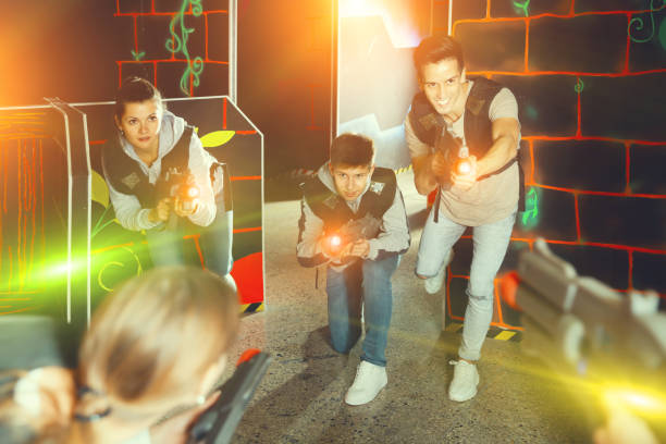 istock Nice people aiming laser guns at players 1252278270