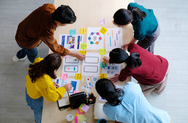 istock Brainstorm planing creative asian teamwork, Group of asia mobile phone app developer team meeting for ideas about screen display prototype smartphone layout, ux startup small business, top view 1252278322