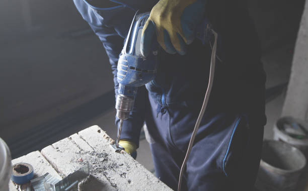 istock Master drills a hole in a metal. Industry 1252278396