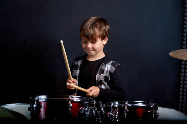 istock Beautiful brunette boy is recording in the studio. Blue background. 1252278720