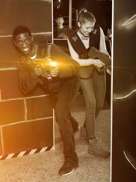 istock Young man and woman playing laser tag 1252284234