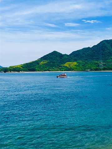 The sea and small boat in the Seto Inland Sea taken from the island of Okuno Island in the Seto Inland Sea, which belongs to Takehara City, Hiroshima Prefecture