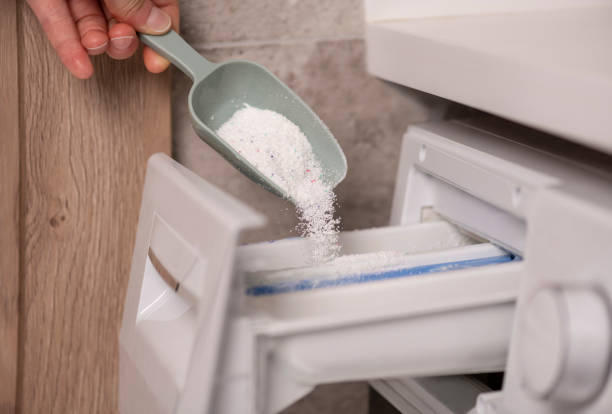 istock Pouring Washing Powder in Washing Machine 1252284940
