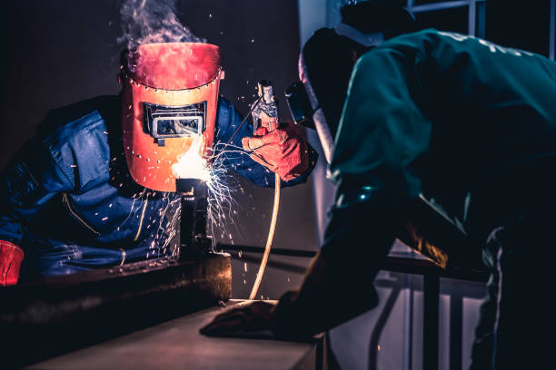 istock Metal welding steel works using electric arc welding machine 1252285428