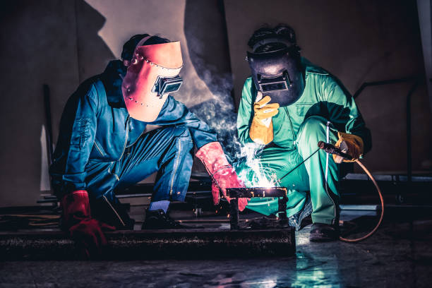 istock Metal welding steel works using electric arc welding machine 1252285437