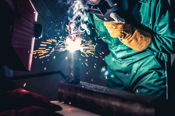 istock Metal welding steel works using electric arc welding machine 1252285457