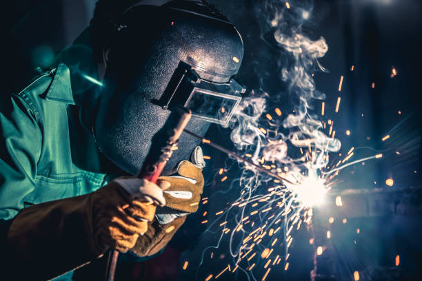 istock Metal welding steel works using electric arc welding machine 1252285460