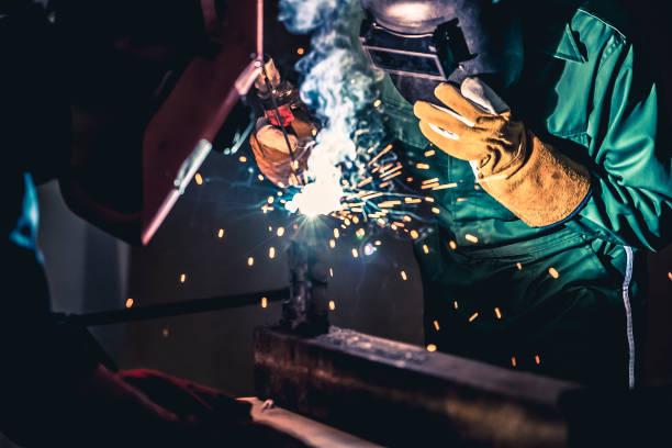 istock Metal welding steel works using electric arc welding machine 1252285463