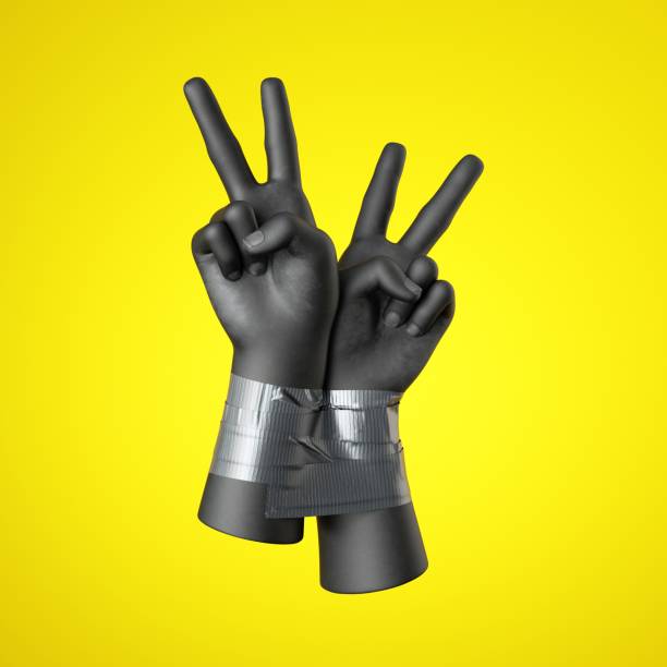 istock 3d render, black human hands tied with tape, isolated on yellow background. Victory gesture. Rebellion and protest concept. Fight for human rights. 1252287712