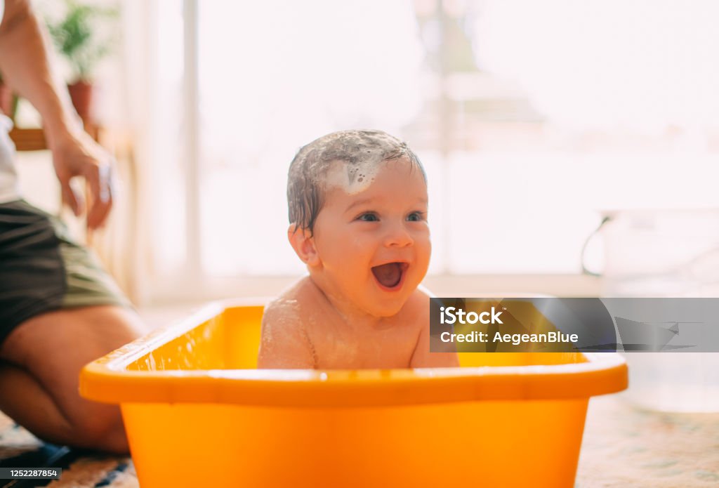 Cute Baby Playing in a Bathtub Baby - Human Age Stock Photo