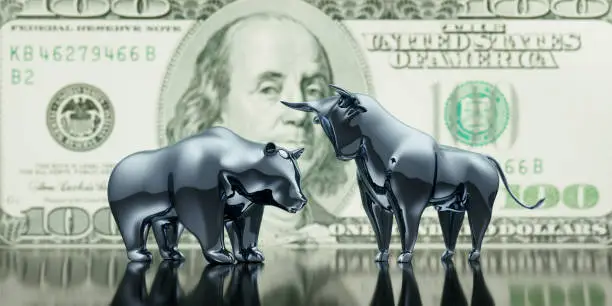 Silver Bull and Bear with 100 Dollar Banknote Background